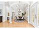 Elegant dining room featuring hardwood floors, white columns, a chandelier, and adjacent entry at 15005 Lake Emerald Blvd, Tampa, FL 33618