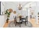 Elegant dining room featuring hardwood floors, white columns, a chandelier, and natural light at 15005 Lake Emerald Blvd, Tampa, FL 33618