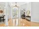 Bright foyer featuring hardwood floors, white columns, and an adjacent office space with hardwood floors at 15005 Lake Emerald Blvd, Tampa, FL 33618