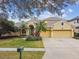 Charming two-story home with manicured landscaping, a three-car garage, and inviting curb appeal at 15005 Lake Emerald Blvd, Tampa, FL 33618