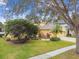 Charming single-Gathering home with a manicured lawn, mature trees and tropical plants at 15005 Lake Emerald Blvd, Tampa, FL 33618