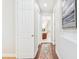 Hallway featuring hardwood floors and natural light at 15005 Lake Emerald Blvd, Tampa, FL 33618