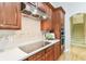 Elegant kitchen with a modern cooktop, backsplash, and staircase in the background at 15005 Lake Emerald Blvd, Tampa, FL 33618