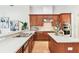 Spacious kitchen featuring stainless steel appliances, light countertops, and wood cabinetry at 15005 Lake Emerald Blvd, Tampa, FL 33618