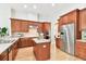 Well-equipped kitchen with stainless steel appliances, an island, and wooden cabinetry at 15005 Lake Emerald Blvd, Tampa, FL 33618