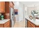 Spacious kitchen with stainless steel appliances, warm wood cabinets, and light countertops at 15005 Lake Emerald Blvd, Tampa, FL 33618