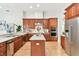 Beautiful kitchen featuring wooden cabinets, stainless steel appliances, and a center island at 15005 Lake Emerald Blvd, Tampa, FL 33618