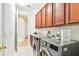 Laundry room features modern washer and dryer, storage cabinets, and tile flooring at 15005 Lake Emerald Blvd, Tampa, FL 33618