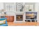 Cozy living room featuring a fireplace, built-in shelving, and a comfortable seating area at 15005 Lake Emerald Blvd, Tampa, FL 33618