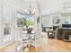 Open-concept living space with dining area leading to the backyard, fireplace, and comfortable seating at 15005 Lake Emerald Blvd, Tampa, FL 33618