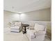 Cozy loft with plush carpeting, two armchairs, and a small table at 15005 Lake Emerald Blvd, Tampa, FL 33618