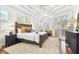 Beautiful main bedroom with tray ceilings, a seating area, hardwood floors and natural light at 15005 Lake Emerald Blvd, Tampa, FL 33618