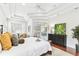 Bright main bedroom featuring a tray ceiling, hardwood floors and sliding glass doors at 15005 Lake Emerald Blvd, Tampa, FL 33618