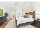 Spacious main bedroom with a tray ceiling, hardwood floors and neutral colors at 15005 Lake Emerald Blvd, Tampa, FL 33618
