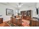 Well-lit home office features hardwood floors, built-in bookcase, and a large wooden desk at 15005 Lake Emerald Blvd, Tampa, FL 33618