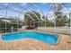 Inviting screened-in pool with brick pavers, a tranquil water feature, and lush landscaping at 15005 Lake Emerald Blvd, Tampa, FL 33618