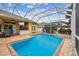 Outdoor pool with a covered patio and a built-in barbecue area, ideal for outdoor living and gatherings at 15005 Lake Emerald Blvd, Tampa, FL 33618