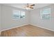 A bright bedroom with wood-look flooring and two windows providing lots of natural light at 3030 5Th N Ave, St Petersburg, FL 33713