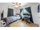 Comfortable bedroom with ceiling fan, laminate floors, and natural light at 3030 5Th N Ave, St Petersburg, FL 33713