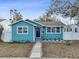 Charming teal bungalow featuring a well-kept lawn and an inviting front porch at 3030 5Th N Ave, St Petersburg, FL 33713