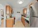 View of kitchen featuring stainless steel refrigerator, microwave, granite countertops, and wood cabinetry at 3030 5Th N Ave, St Petersburg, FL 33713