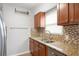 A kitchen showcasing granite countertops, stainless steel appliances, and mosaic backsplash, providing a modern aesthetic at 3030 5Th N Ave, St Petersburg, FL 33713