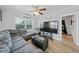 Bright living room with a comfortable gray sectional couch and a large flat screen television at 3030 5Th N Ave, St Petersburg, FL 33713