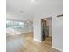 Sunlit living room with hardwood floors and a modern stainless steel refrigerator at 3030 5Th N Ave, St Petersburg, FL 33713