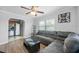 Comfortable living room featuring a large gray sectional couch, wood floors, and natural light at 3030 5Th N Ave, St Petersburg, FL 33713