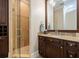 Bathroom with a walk-in shower with glass door, granite countertop, and dark wood cabinets at 310 8Th N Ave, St Petersburg, FL 33701