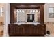 A bathroom vanity with and sinks, dark wood cabinets, and a granite countertop at 310 8Th N Ave, St Petersburg, FL 33701