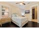 A well-lit bedroom with a view of a modern mounted television, dark wood floors, and an ensuite bathroom at 310 8Th N Ave, St Petersburg, FL 33701