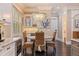 Bright dining area with round table, wicker chairs, stylish lighting, and adjacent bar with wine storage at 310 8Th N Ave, St Petersburg, FL 33701