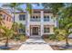 Beautiful two-story home with a balcony, lush landscaping, and a decorative walkway leading to the entrance at 310 8Th N Ave, St Petersburg, FL 33701