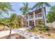 Inviting two-story home with a balcony, lush landscaping, and decorative walkway on a sunny day at 310 8Th N Ave, St Petersburg, FL 33701