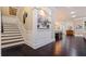 Welcoming foyer showcasing dark hardwood floors, staircase, and decorative niche with artwork at 310 8Th N Ave, St Petersburg, FL 33701