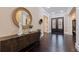 Elegant foyer with dark wood floors, a round decorative mirror, and an entry to the home at 310 8Th N Ave, St Petersburg, FL 33701