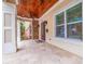 Charming front porch featuring stone accents, wood ceilings, and a tiled floor at 310 8Th N Ave, St Petersburg, FL 33701
