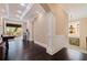 Hallway with dark wood floors, white trim, and an opening to an outdoor covered porch at 310 8Th N Ave, St Petersburg, FL 33701