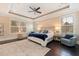 Comfortable bedroom with a tray ceiling, area rug, and large windows with wood shutters at 310 8Th N Ave, St Petersburg, FL 33701
