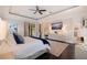 Relaxing main bedroom with a ceiling fan, dark wood floors, and access to the main bathroom at 310 8Th N Ave, St Petersburg, FL 33701