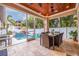 Beautiful screened outdoor patio with tiled floors, dining table, and pool view at 310 8Th N Ave, St Petersburg, FL 33701