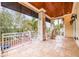 Covered outdoor porch area with stone floors and a wooden ceiling with outdoor seating at 310 8Th N Ave, St Petersburg, FL 33701