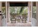 Relaxing covered porch with stone flooring and rocking chairs overlooking lush landscaping at 310 8Th N Ave, St Petersburg, FL 33701