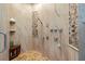 Walk-in shower with travertine tile, a built-in seat, and mosaic tile accents at 310 8Th N Ave, St Petersburg, FL 33701