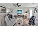 Cozy living room featuring a ceiling fan, a TV, and comfortable seating at 3401 W Paris St, Tampa, FL 33614