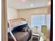 Cozy bedroom featuring a bunk bed, chair and neutral decor at 4352 Tahitian Gardens Cir # E, Holiday, FL 34691