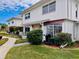 Exterior of condo featuring well-maintained lawn and stone accents at 4352 Tahitian Gardens Cir # E, Holiday, FL 34691