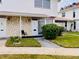 Charming condo entrance with stone accent wall and manicured lawn at 4352 Tahitian Gardens Cir # E, Holiday, FL 34691