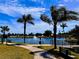 Scenic lake view with palm trees and walking path at 4352 Tahitian Gardens Cir # E, Holiday, FL 34691